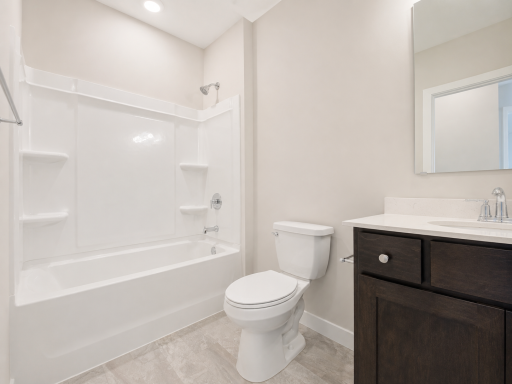 Well-appointed full bathroom with a spacious vanity and tub/shower combination, conveniently located near the secondary bedroom.