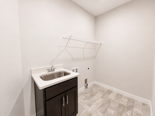Dedicated laundry room with utility sink, upper wire shelving, and space for side-by-side washer and dryer.