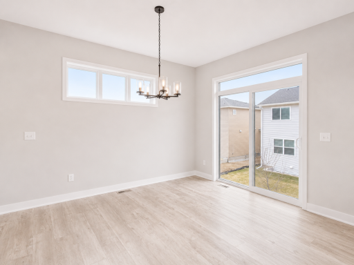 Bright dining space with oversized sliding glass doors providing abundant natural light and seamless access to the backyard.