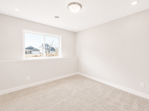 Spacious lower-level bedroom with natural light, generous closet space, and flexibility for guests, family, or a private home office.
