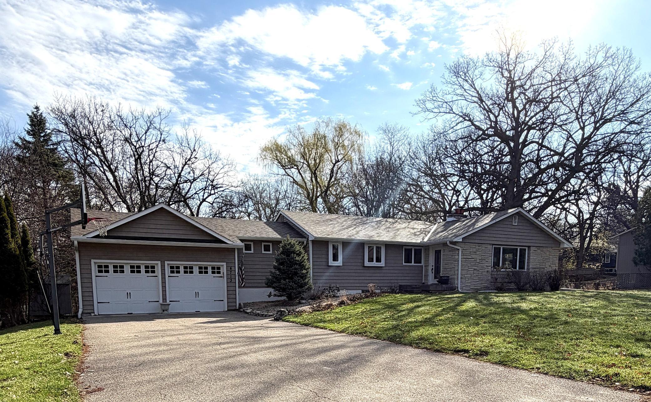 Updated & move-in ready! 4BR (2 main, 2 lower) & 3BA, including a private primary 3/4 ensuite. Walk-out lower level opens to a lush .5-acre wooded lot in Minnetonka Schools. The perfect blend of modern comfort & a serene, natural setting.