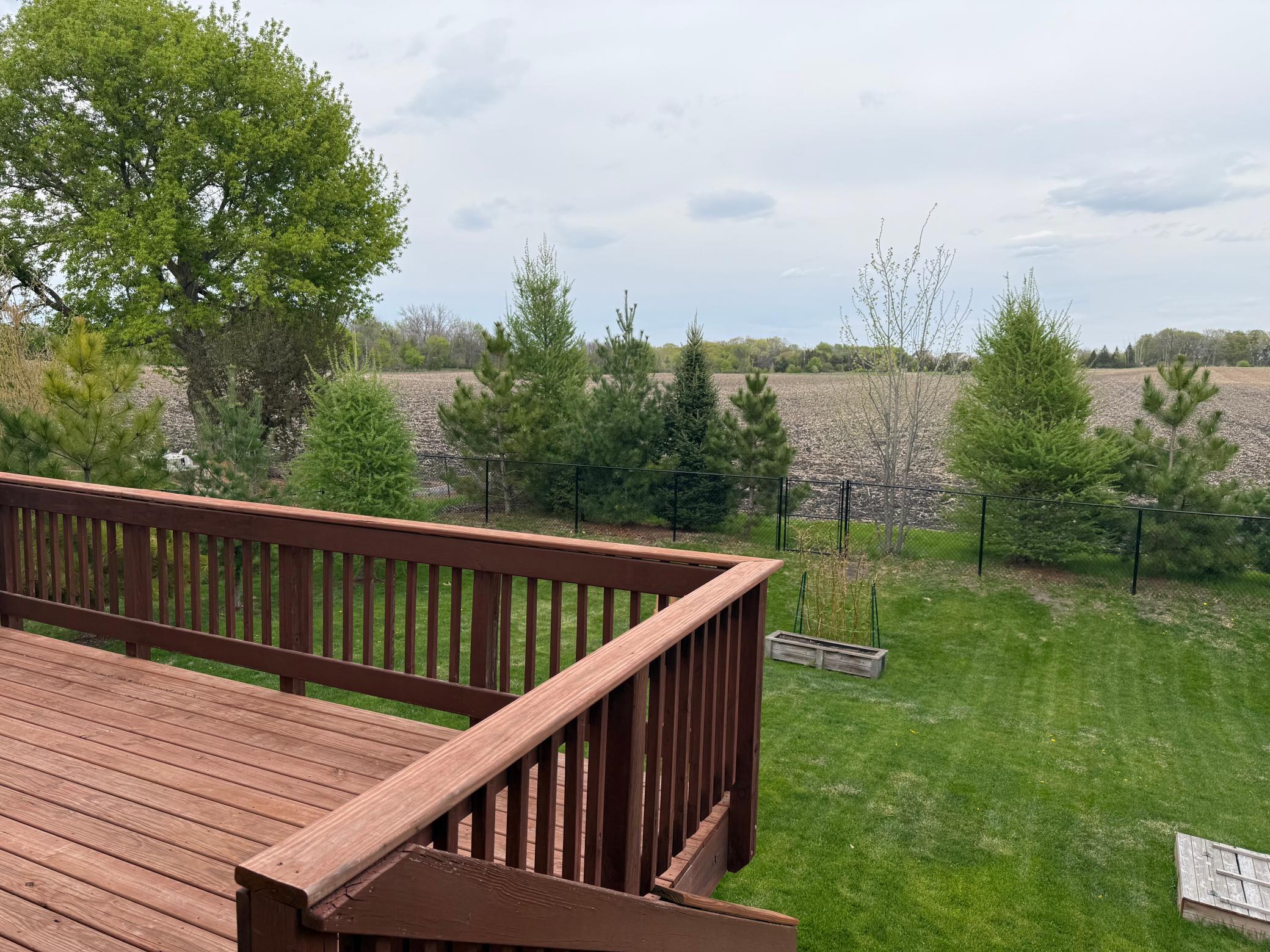 The spacious 12' x 16' deck overlooks the private backyard and is the perfect place for grilling, relaxing, or entertaining while enjoying peaceful views of the outdoor space.