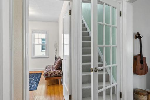 Stairway leading to upstairs primary bedroom
