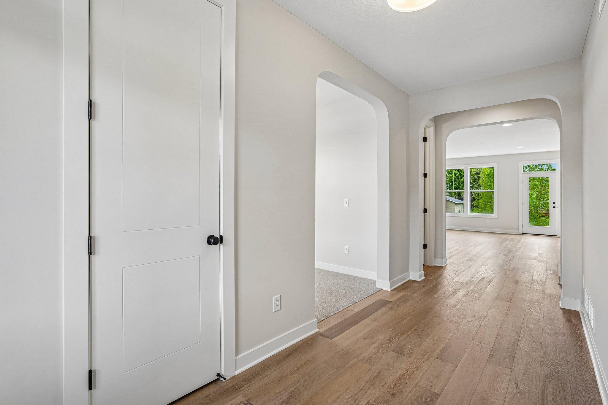 Wide extended foyer with beautiful engineered wood flooring.