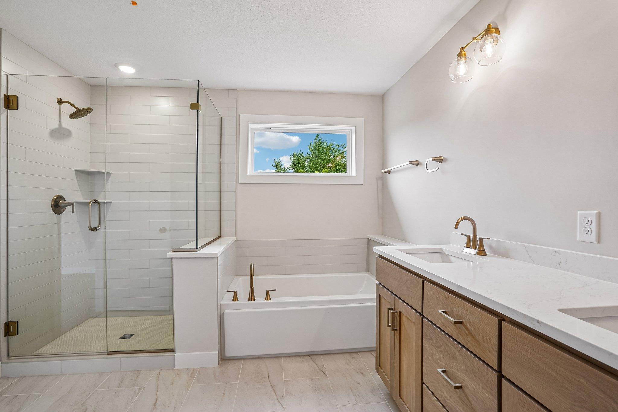 Clean and Simple Slip in Tub with Ceramic Tile Splash - Metal Framed Mirrors at Vanity to come!