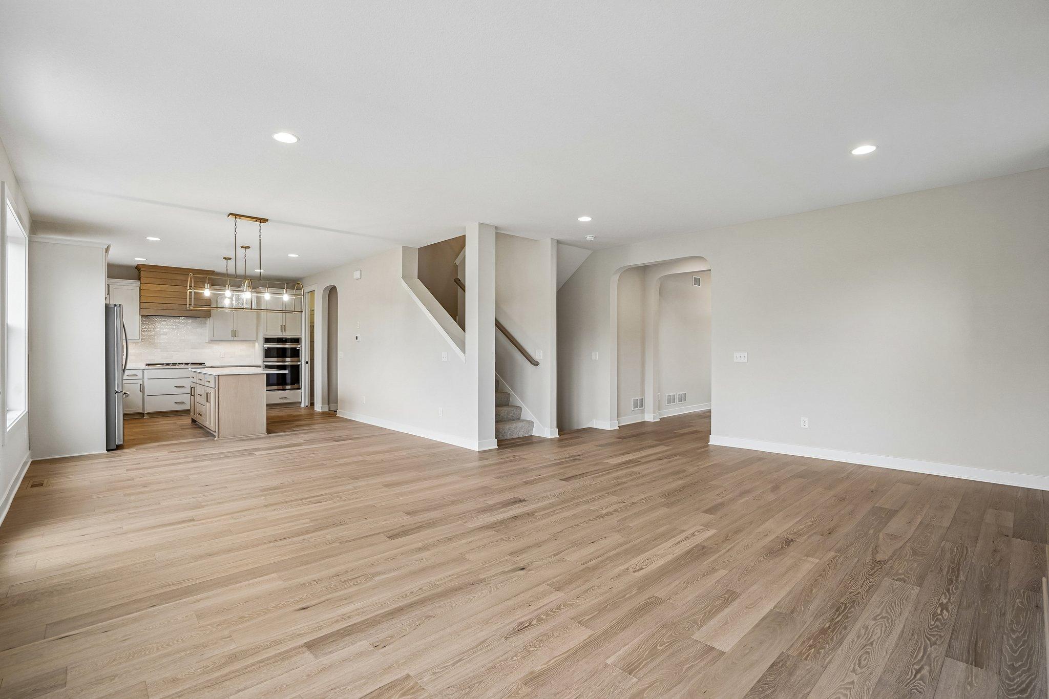 Engineered wood through most of main level creating a cohesive and inviting feel, natural arches at walkways create balance and visual appeal!