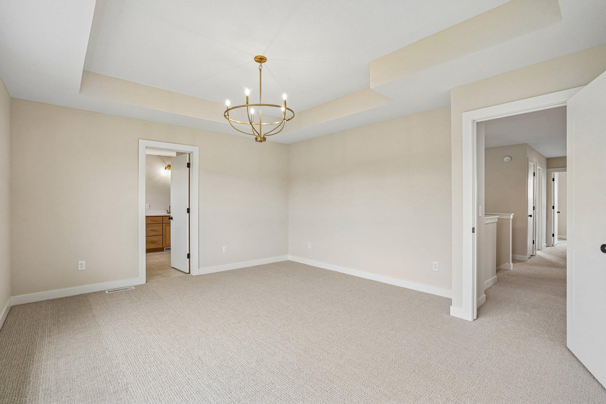 Primary Bedroom with Box Vaulted Ceiling and Switched outlets on bedsides for convenience!