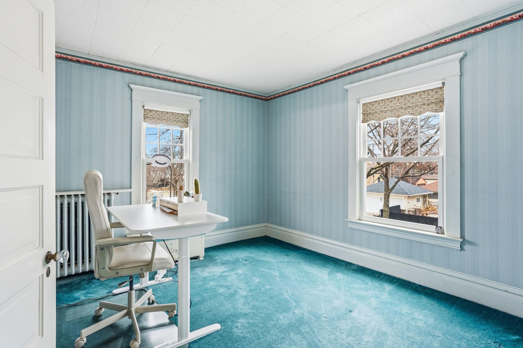 Second bedroom with east and south facing windows .