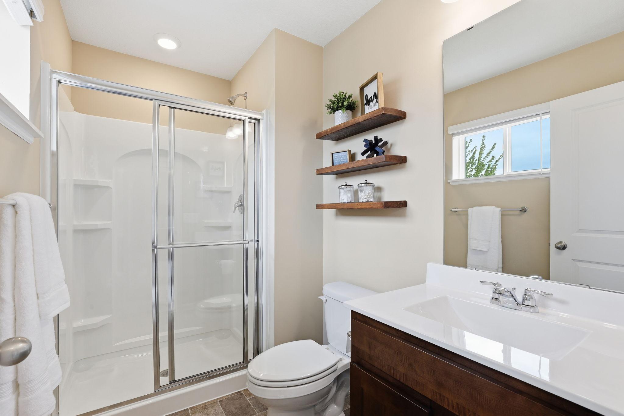 Well-appointed 3/4 bath conveniently located across from the second bedroom, offering modern finishes and functional design.