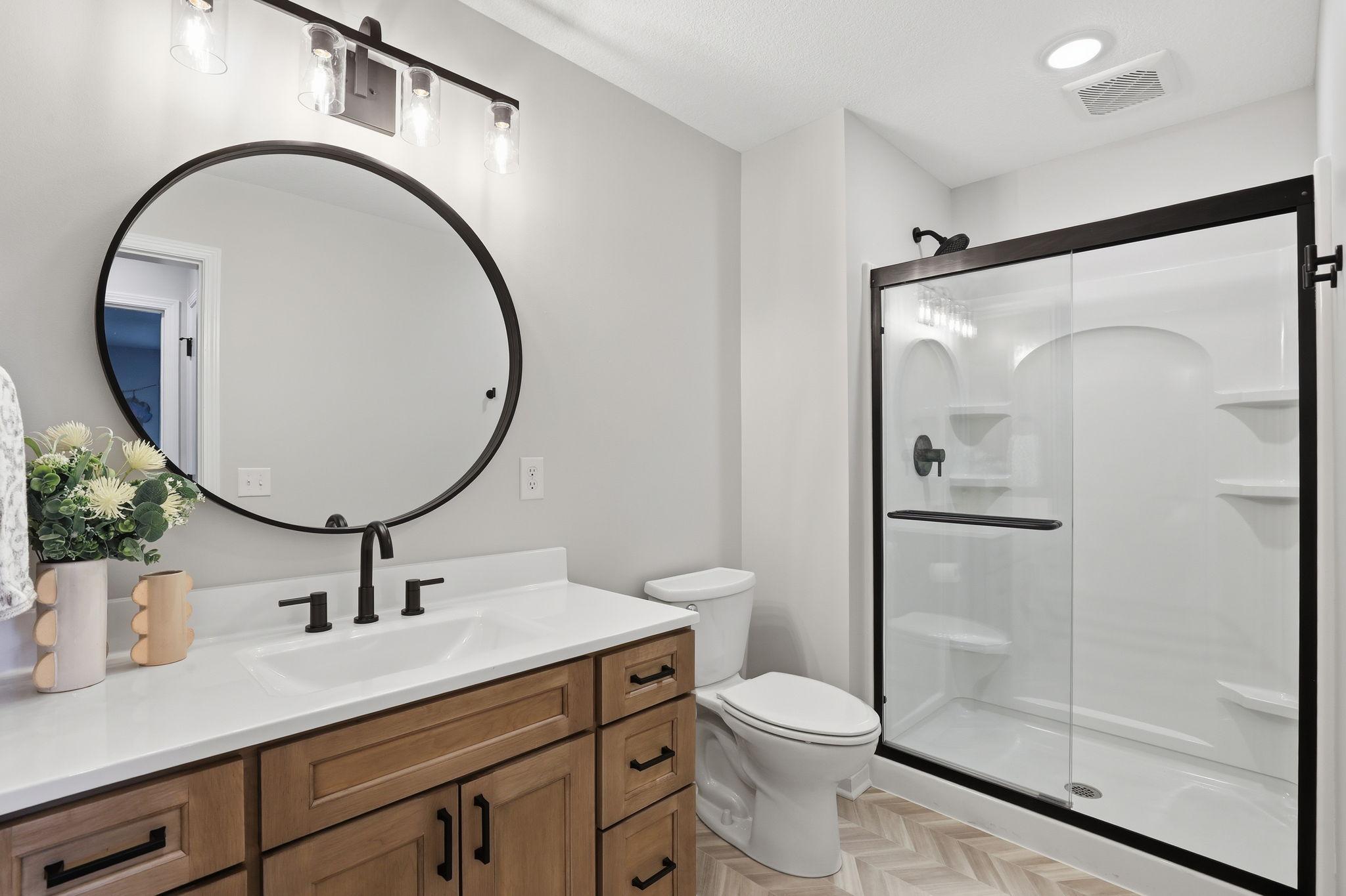 Lower-level 3/4 bathroom adds convenience and functionality, bringing the home to a total of five bathrooms.