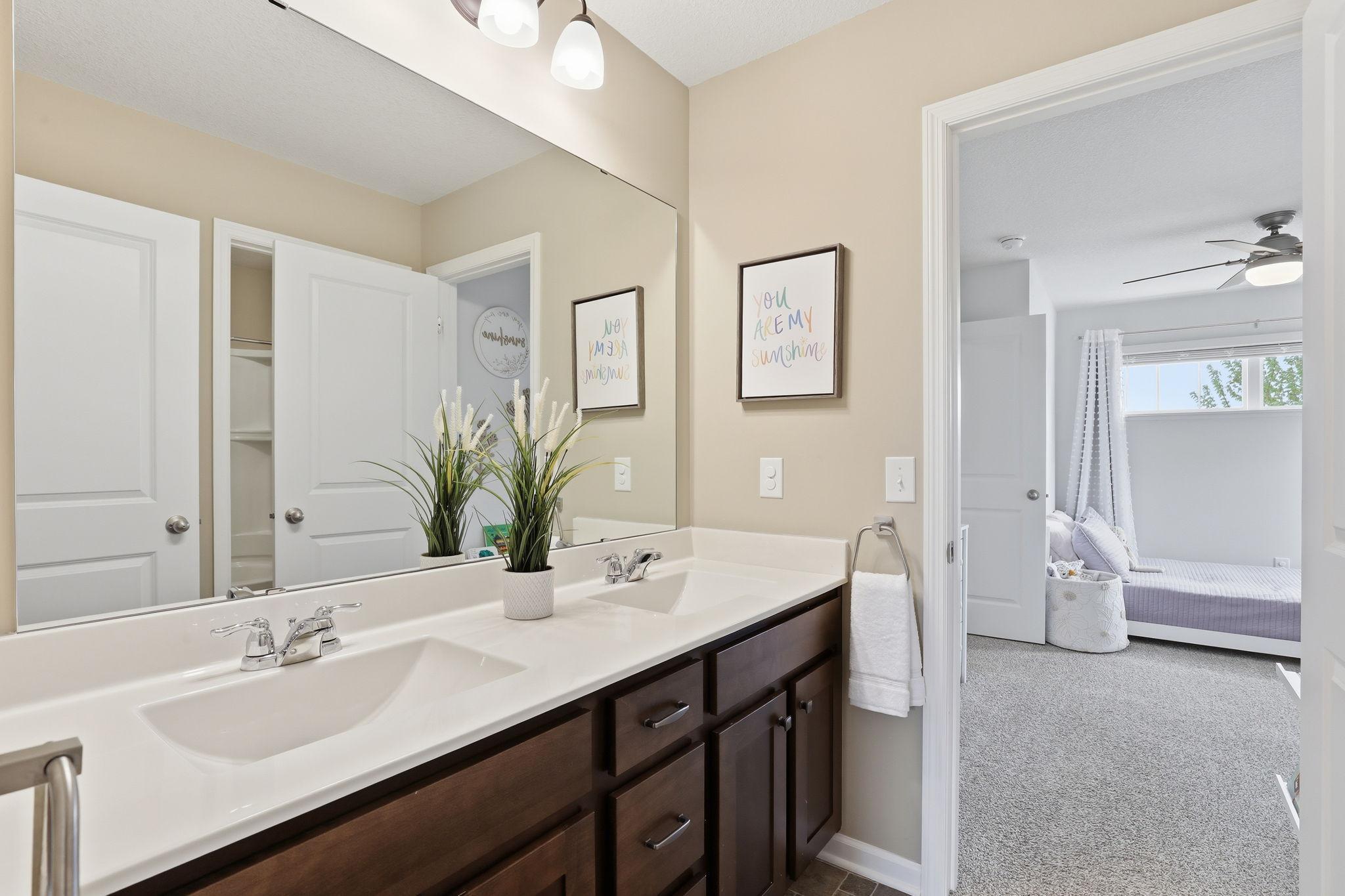 Jack and Jill bathroom featuring a double vanity, providing added convenience and shared functionality for adjoining bedrooms.