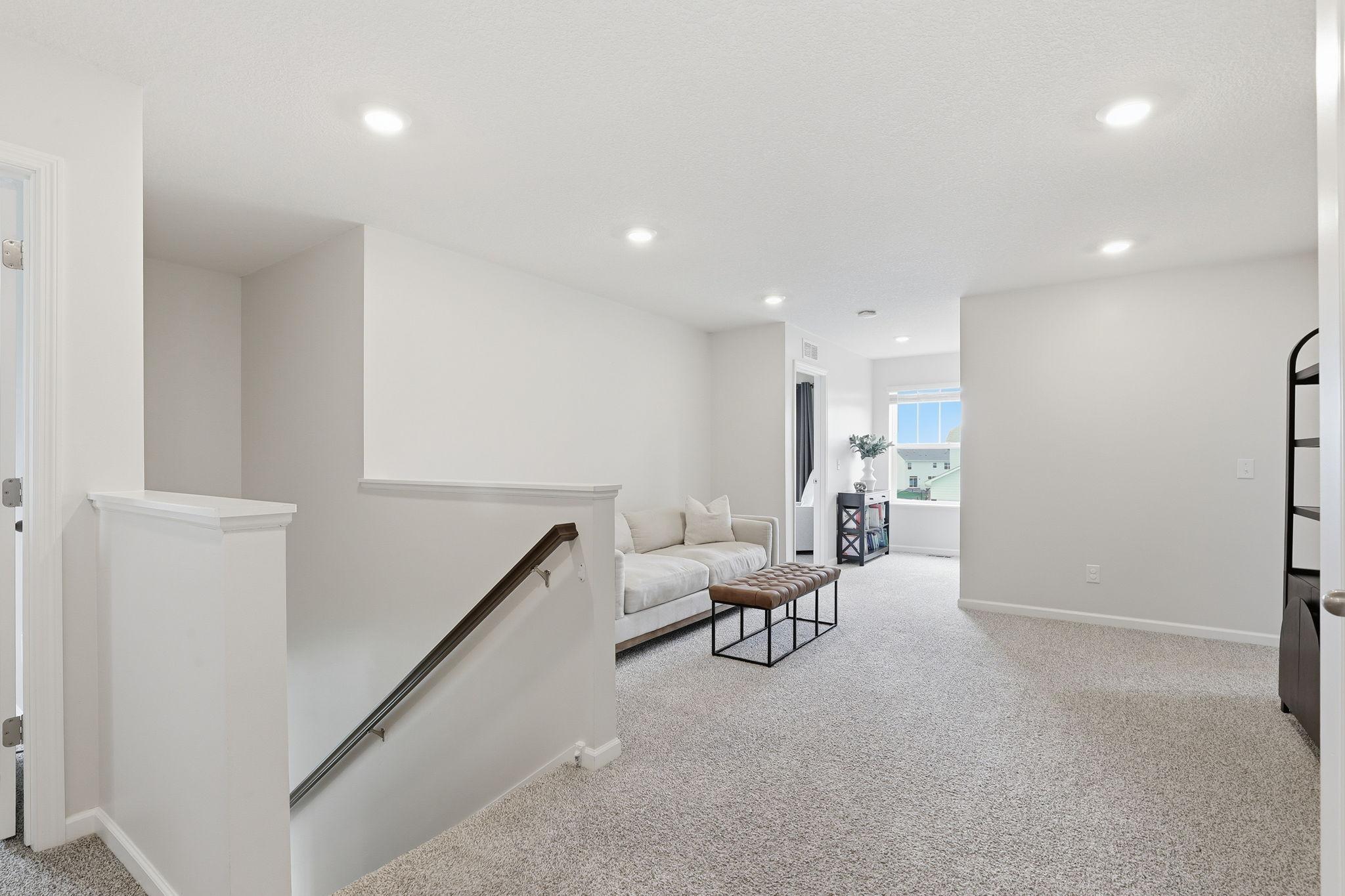 Versatile loft space offering flexible use as a second living area, home office, or playroom.