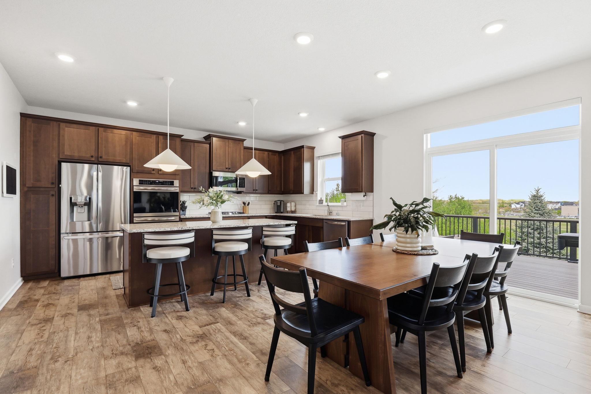 Sliding doors off the dining room open to a NEW maintenance-free deck (2021), creating a seamless indoor-outdoor living space