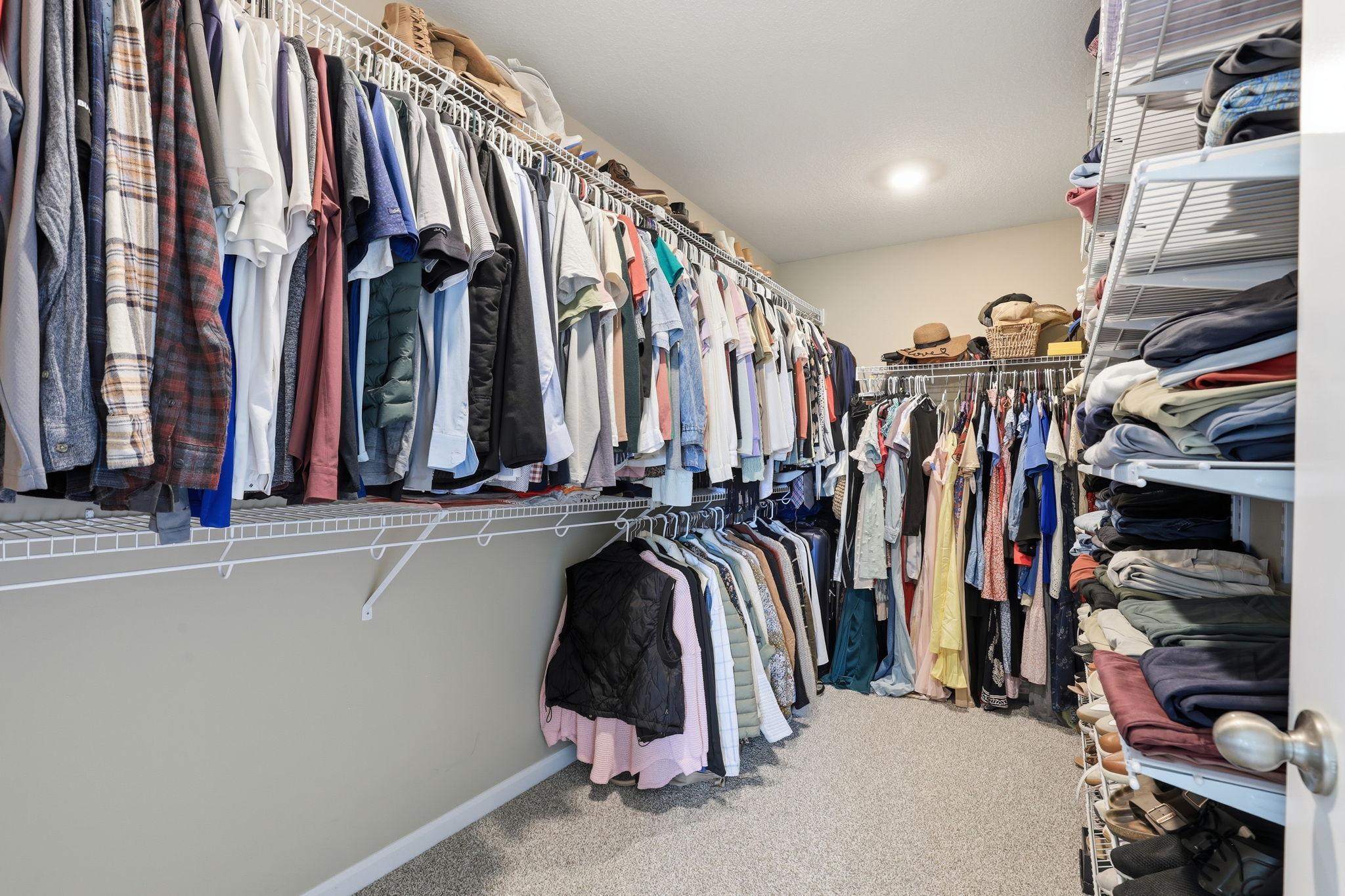 Primary walk-in closet offering generous storage space with organized shelving and hanging areas for easy everyday living.
