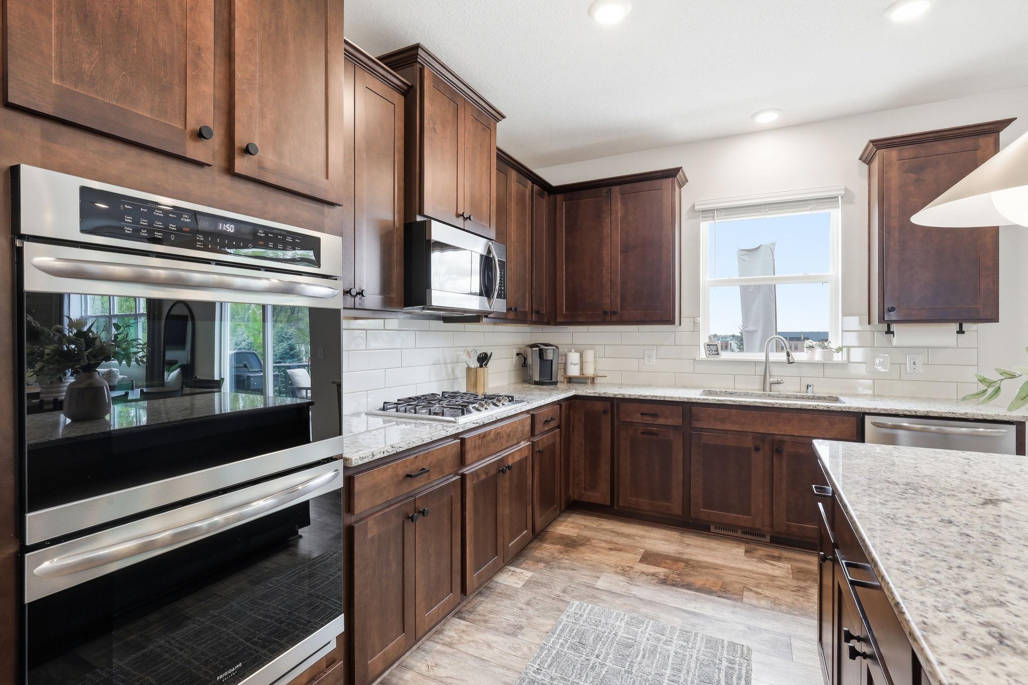 Stainless steel appliances include a convenient double oven, combining modern style with everyday cooking functionality.