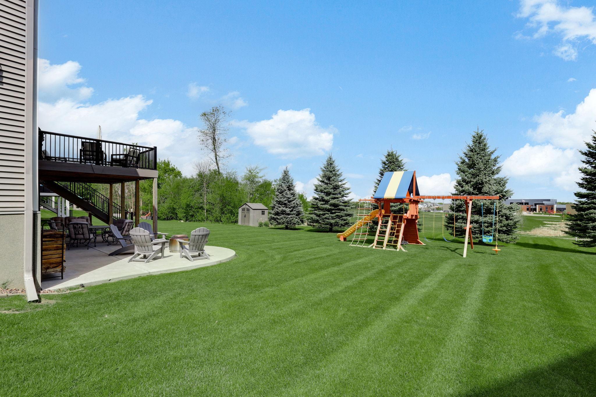 Spacious yard with in-ground sprinklers (2020) and invisible fencing (2020), offering easy maintenance and added convenience for pets.