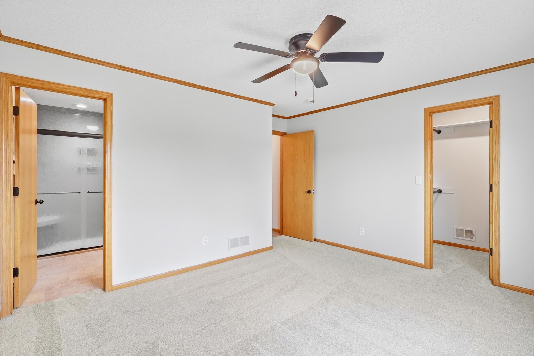 Primary Bedroom offers walk in closet, new ceiling fan and walk-through into bath.