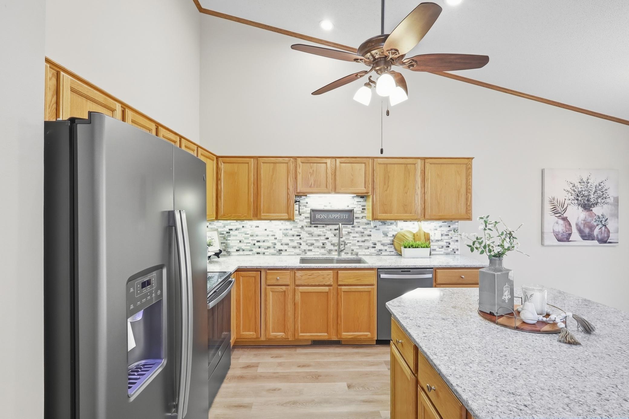 Tiled backsplash, granite counters, composite sink, SS appliances and under cabinet lights make this a dreamy kitchen.
