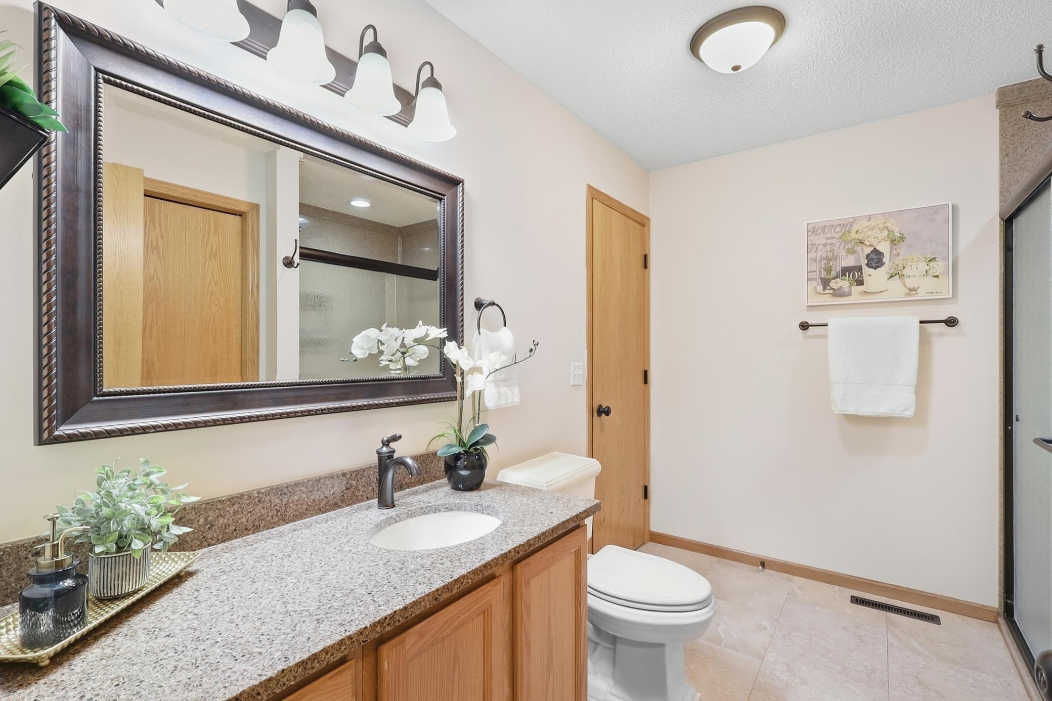 Upper level 3/4 bath has been updated with granite counters and solid surround shower. Be sure and notice the large linen closet behind the door.