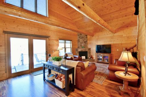 Main Floor Living Room Showcasing Log Beams and Natural Lighting