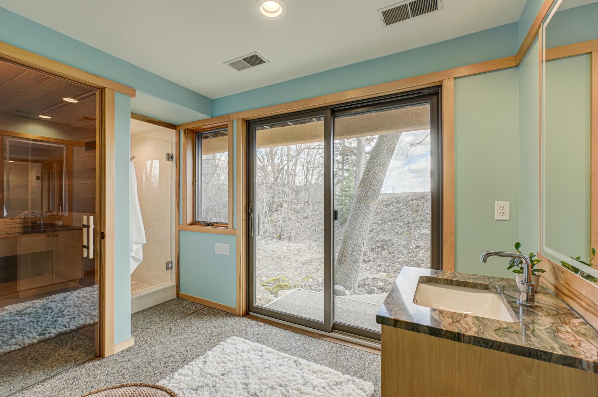 Lower level bathroom with access to private yard area and pond