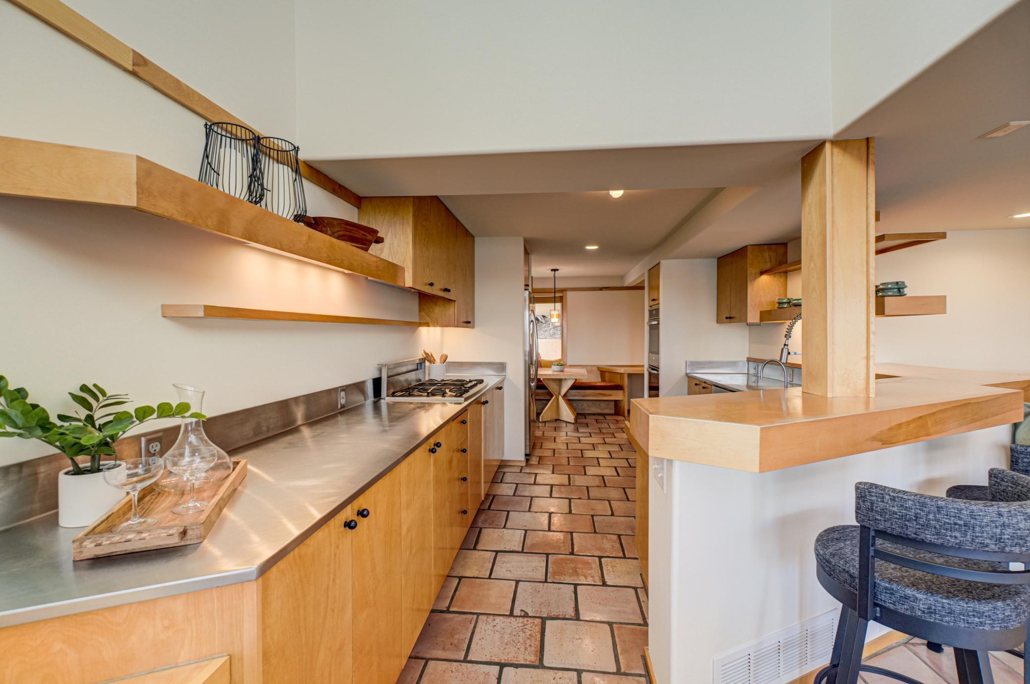 Stainless countertops provide a modern prep area
