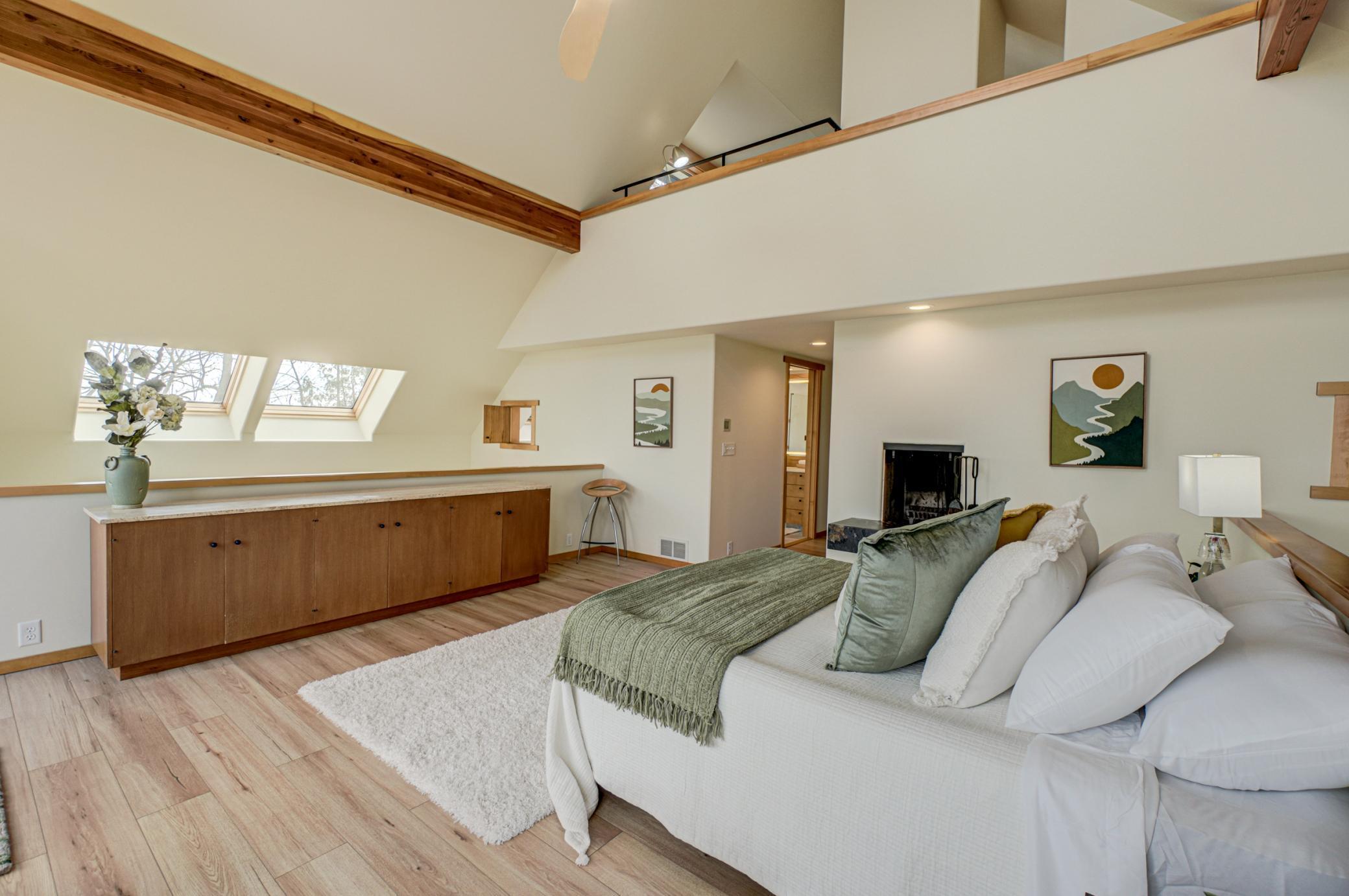 The primary bedroom opens to the main level below and the top level "eagle's nest"