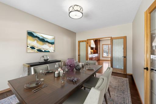 Image has been virtually staged. Full glass French doors connect the kitchen to a versatile flex room (staged as formal dining), equally suited for an office or playroom, with access from both the foyer and kitchen.