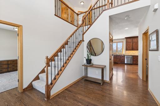Impressive front entry featuring an 8â decorative glass door that opens to a dramatic two-story foyer
