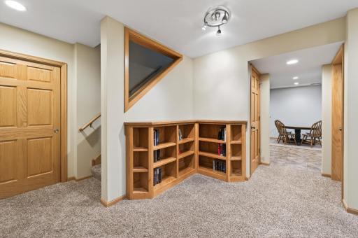 Lower-level sitting area enhanced with built-in corner bookcase and ample walk-in storage