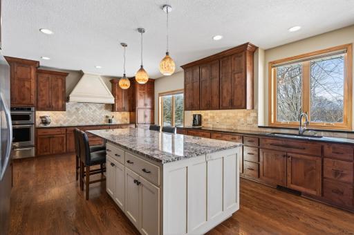 Expansive eat-in center island finished in a beautifully glazed cream enamel, ideal for gathering and entertaining