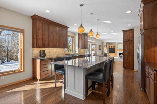 A blend of recessed lighting and statement pendant fixtures creates both warmth and functionality