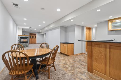 Dedicated lower-level wet bar area with tile flooring