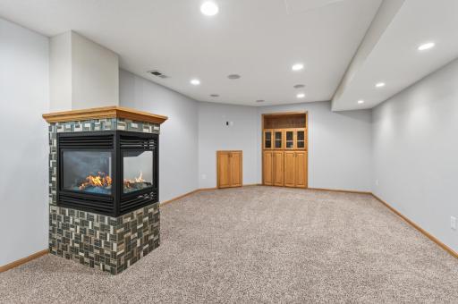 Three-Sided Gas Fireplace: Mosaic tile surround with oak mantel.