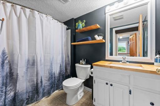 Nearby full bathroom with walk-in hall closet for abundant storage.