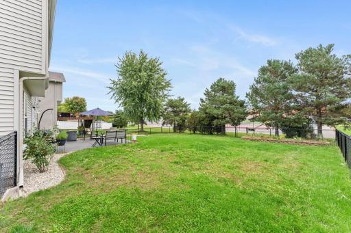 The spacious backyard is fully fenced and features a large stone garden ready for planting.