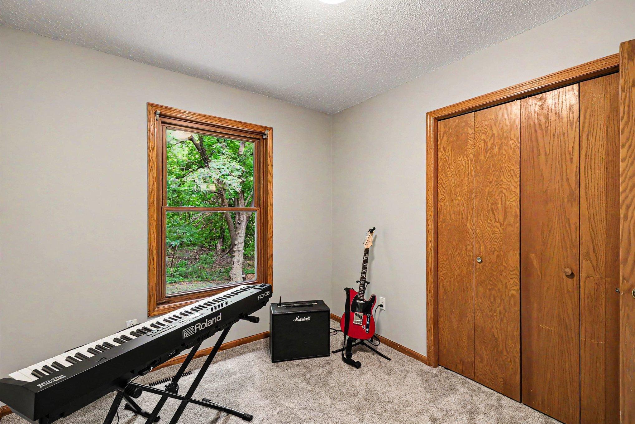 the third bedroom also with an amazing view of all the green and nature that the backyard has to offer