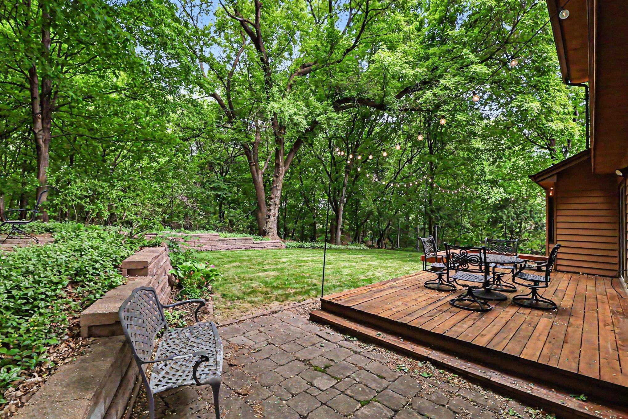 Large deck and lower patio anchors this amazing backyard