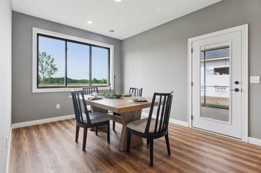 A sunny dining room leads to a covered and screened patio