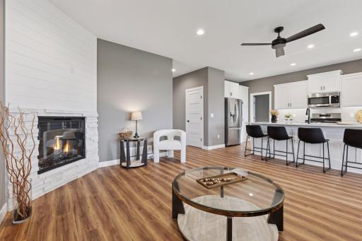A cozy gas fireplace with stone and shiplap