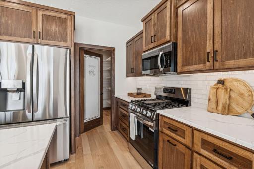 A huge walk in pantry with auto lighting and custom shelving