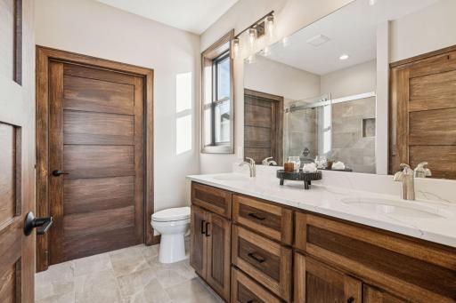 This owners bath offers tile flooring and double sinks.