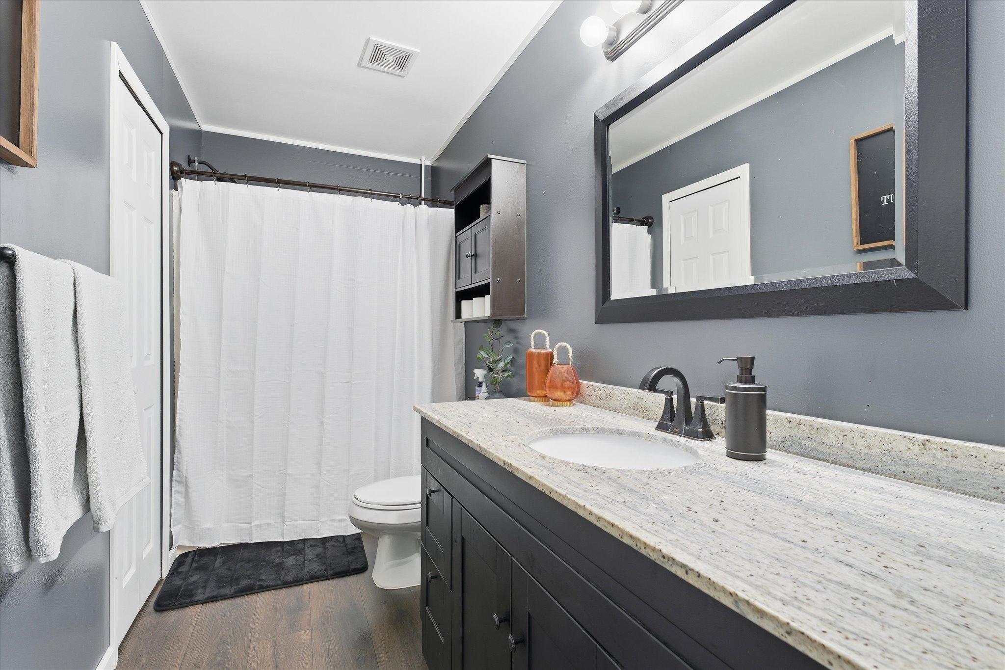 Full bathroom with clean finishes.
