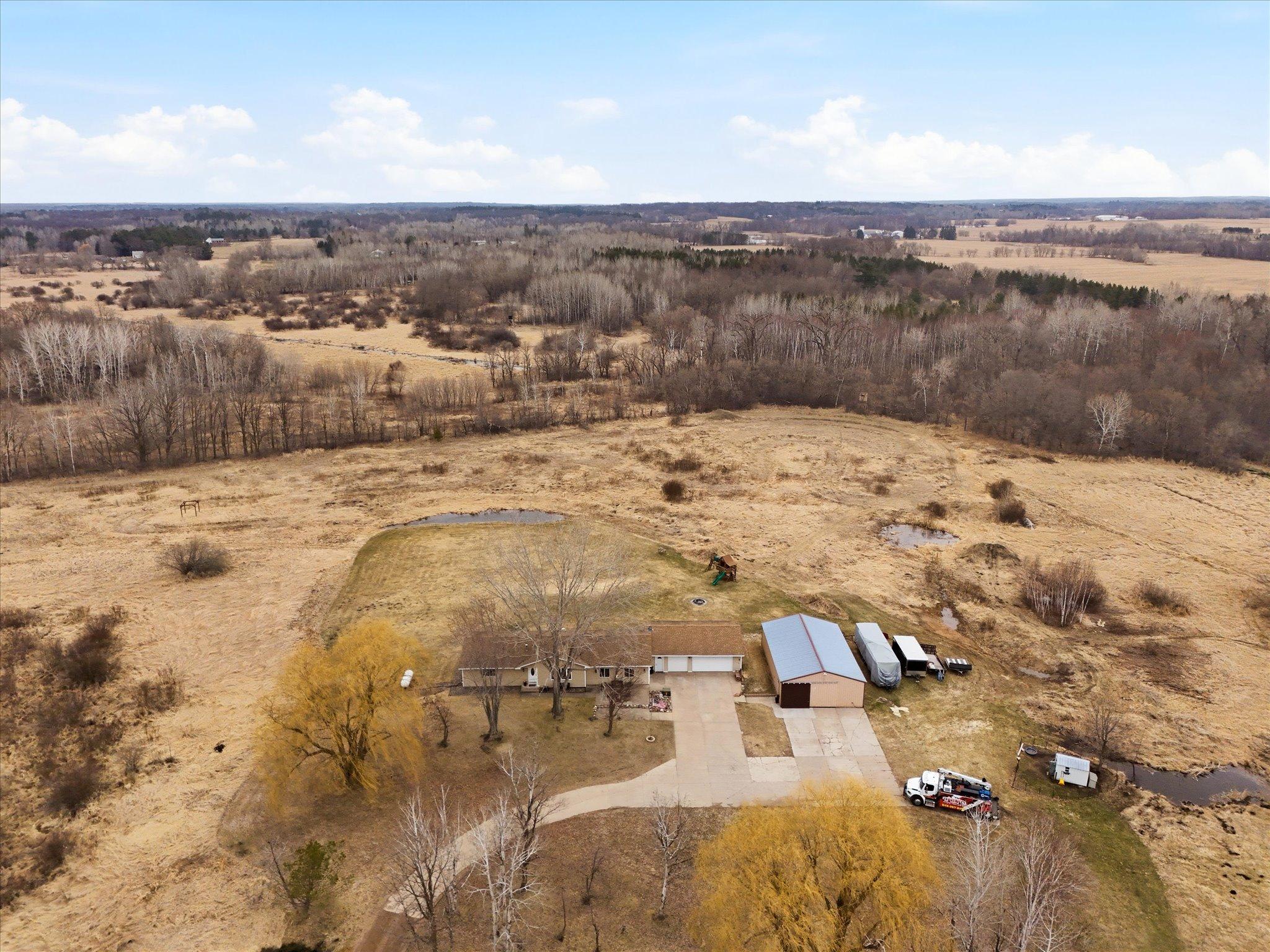 Peaceful setting with open land, mature trees, and natural surroundings.