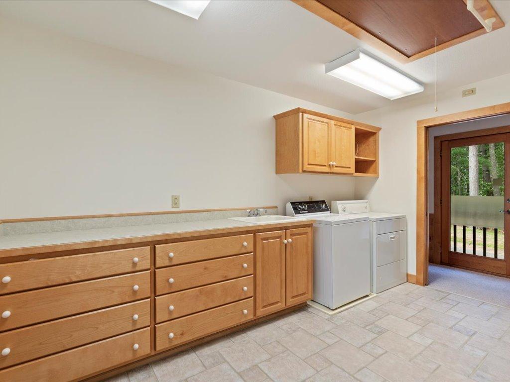 Exceptional storage and organization space complement the main-level living design, with attic access above offering potential for additional customized closet space.