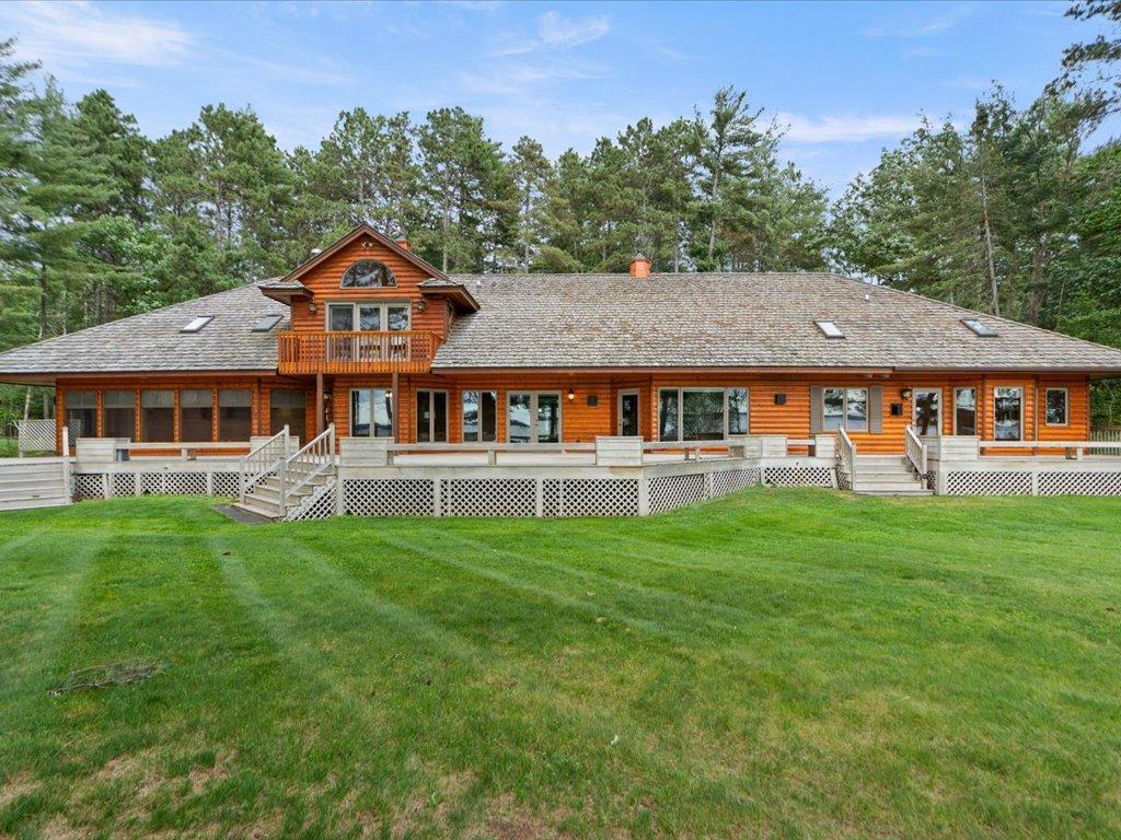 Designed to embrace its waterfront setting, the home's expansive lakeside elevation offers generous outdoor living spaces and sweeping views across Upper Whitefish Lake.