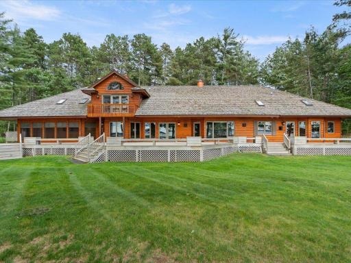 Designed to embrace its waterfront setting, the home's expansive lakeside elevation offers generous outdoor living spaces and sweeping views across Upper Whitefish Lake.