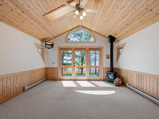 Vaulted ceilings, a gas stove, and private deck access create a comfortable upper-level retreat with glimpses of Upper Whitefish Lake.