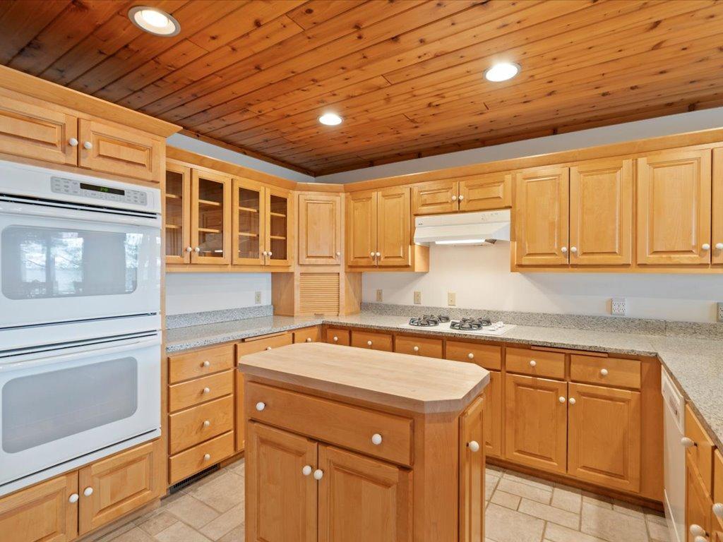 Abundant cabinetry, extensive counter space, and a center island create a kitchen designed to accommodate everything from intimate meals to large family gatherings.