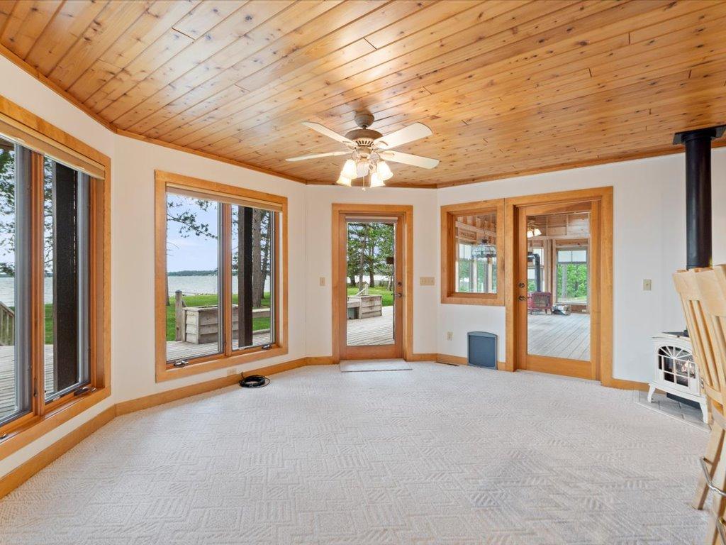 The dining area enjoys beautiful lake views and seamless access to both the lakeside deck and vaulted three-season porch.